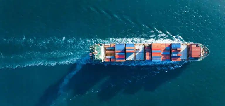 Using a WMS to Stay Competitive in a New Tariff Landscape 4 Container Ship Crossing Ocean 768x364 1